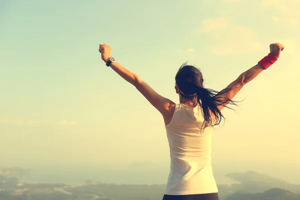 woman raising arms