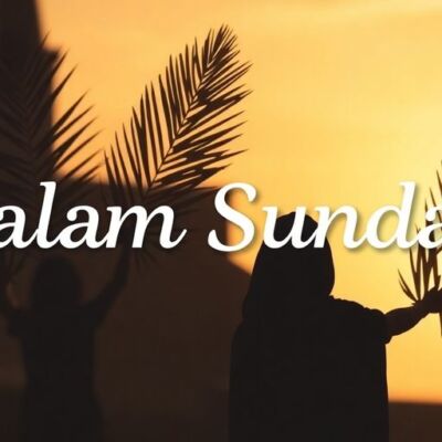 Silhouetted figures with palm branches at sunset.
