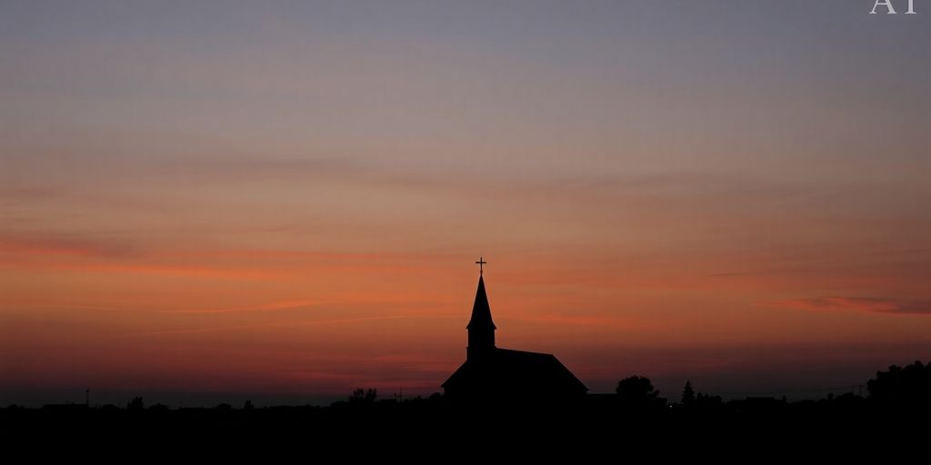Silhouetted church against a colorful dusk sky.