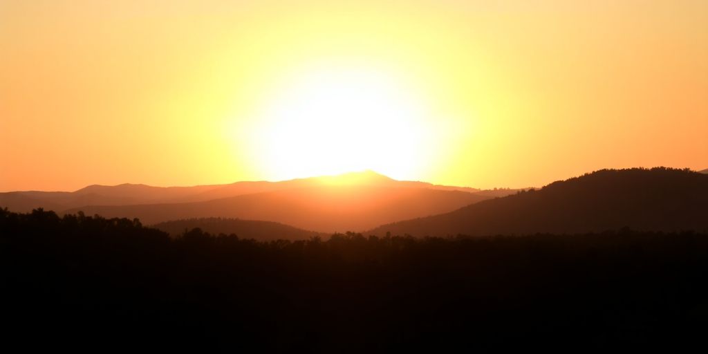 Silhouetted landscape at sunrise, conveying hope and renewal.
