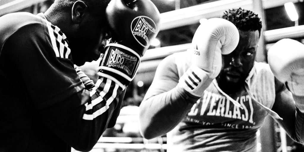 two men wearing boxing gloves