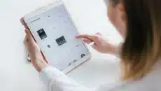 Person browsing drawings on tablet